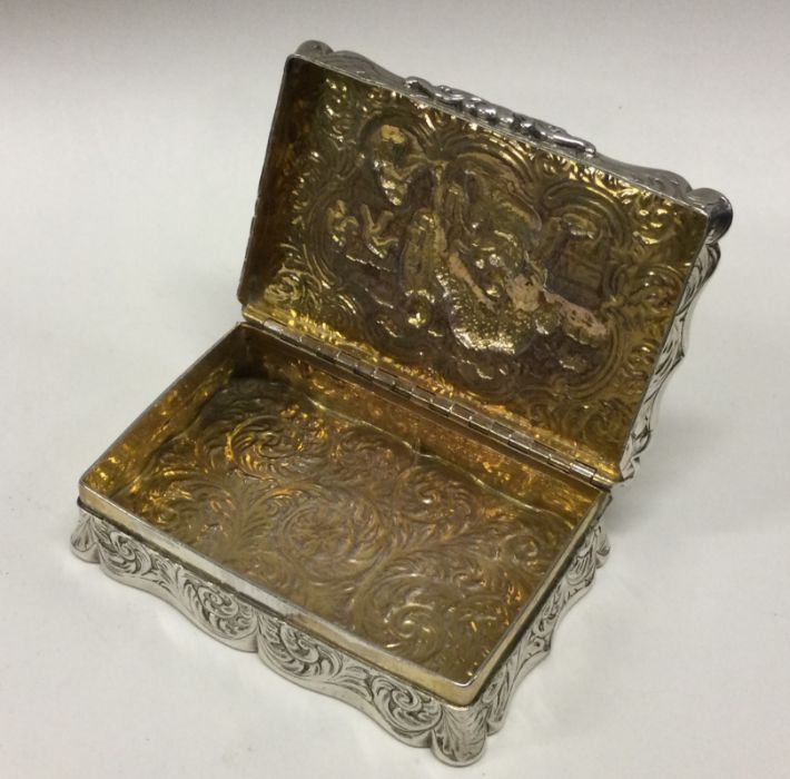 A Victorian Dutch silver chased silver hinged snuff box bearing import marks. Approx. 139 grams. - Image 2 of 2