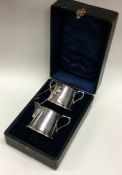 A cased silver sugar bowl and cream jug. Birmingham 1914. By Jones and Crompton. Approx. 125