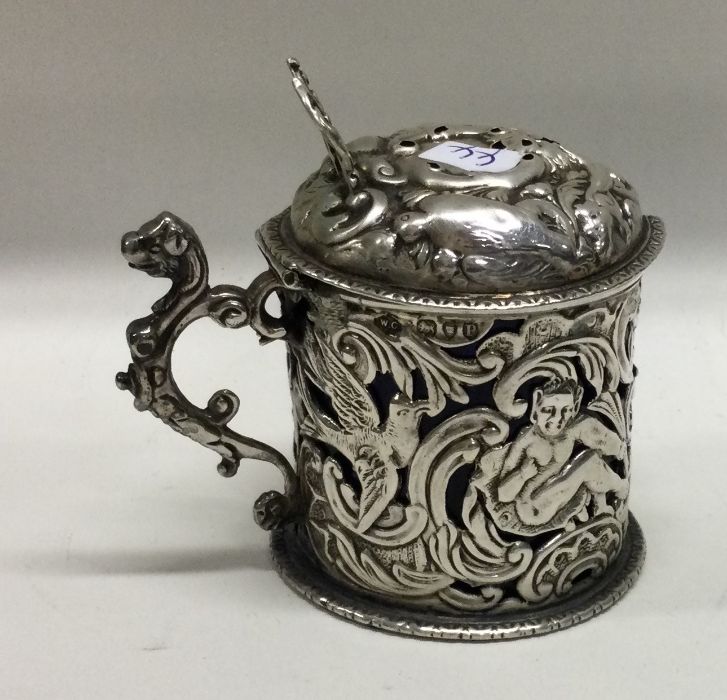 A Victorian silver mustard pot pierced with devils and birds. London 1890. By William Comyns.