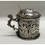 A Victorian silver mustard pot pierced with devils and birds. London 1890. By William Comyns.