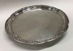 A Chinese silver salver chased with flowers to border. Circa 1880. By Wang Hing. Approx. 194