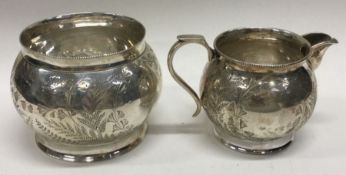 An engraved Victorian aesthetic movement silver sugar and cream. Birmingham 1887. By H Bros. Approx.