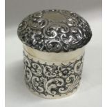 An embossed silver top box chased with flowers and