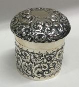 An embossed silver top box chased with flowers and