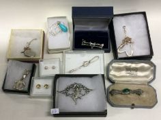 A good collection of silver mounted brooches, pend