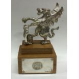 A rare silver cast model of the ‘Queen’s Beast’ on wooden base. London 1973. Approx. 377 grams gross