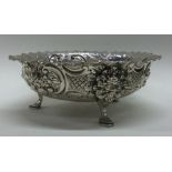 A good chased Victorian silver bowl on feet cast with lion masks. London 1889. By Charles Edwards.