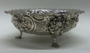 A good chased Victorian silver bowl on feet cast with lion masks. London 1889. By Charles Edwards.