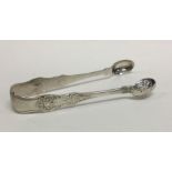 A heavy pair of chased silver ice tongs. London 1894. By GMJ. Approx. 67 grams. Est. £60 - £80.