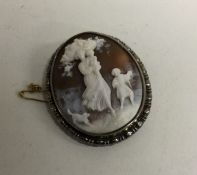 A silver framed cameo in relief together with one