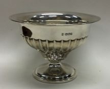 A heavy silver sugar bowl of half fluted design. S