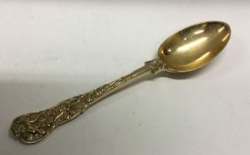 A heavy Bacchanalian pattern Victorian silver gilt dessert spoon.  London 1893. Approx. 75 grams.