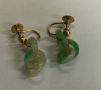 A pair of gold mounted jade drop earrings. Approx.