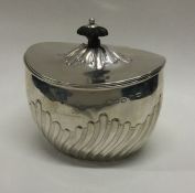 A silver fluted tea caddy with hinged lid. Birmingham. Approx. 115 grams. Est. £80 - £120.
