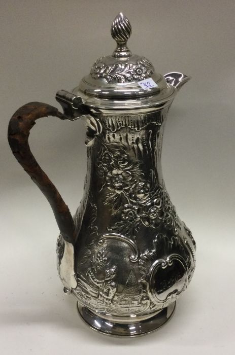 A heavy chased 18th Century Georgian silver jug of Chinoiserie design. London 1766. By Thomas and - Image 2 of 3