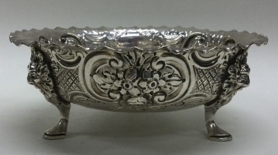 A good chased Victorian silver bowl on feet cast with lion masks. London 1889. By Charles Edwards. - Image 2 of 3