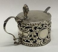 A good chased silver mustard pot decorated with ch