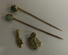 Two gold stick pins together with two gold pendant