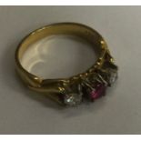 An attractive ruby and diamond three stone ring in 18 carat gold claw mount. Approx. 5 grams
