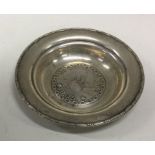 A small silver dish decorated with a boat. Approx.