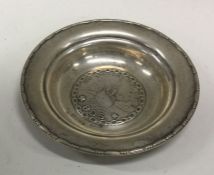 A small silver dish decorated with a boat. Approx.
