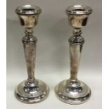 A pair of heavy silver candlesticks. Birmingham 1966. By AT. Approx. grams. Est. £80 - £120.