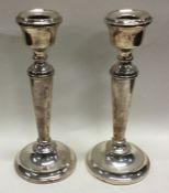A pair of heavy silver candlesticks. Birmingham 1966. By AT. Approx. grams. Est. £80 - £120.