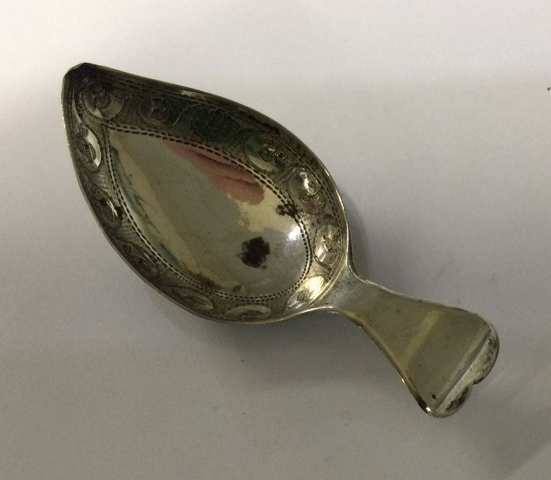 A George III heart shaped silver handled caddy spoon with bright cut bowl. Birmingham 1809. By