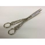 A George III pair of silver grape scissors with shell border. London 1817 Approx.99 grams. Est. £150