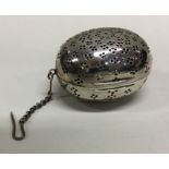 A Victorian silver tea infuser with suspension chain. London 1875. By George Heath. Approx.44 grams.