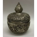 An unusual Thai silver tea caddy chased with elephants and carriages to lift-off lid. Approx. 491