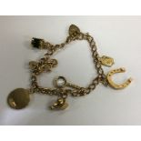 A 9 carat charm bracelet. Approx. 16.4 grams. Est.