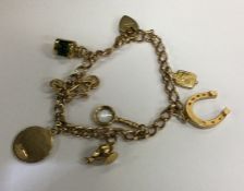 A 9 carat charm bracelet. Approx. 16.4 grams. Est.