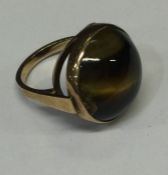 A 9 carat tiger's eye single stone ring. Approx. 6