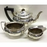 A heavy silver three piece tea set. Sheffield. App