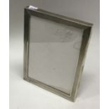 A silver mounted glass engine turned silver frame. Birmingham 1921. By S&M. Est. £50 - £80.