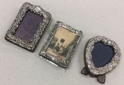 Three embossed silver picture frames. Est. £20 - £