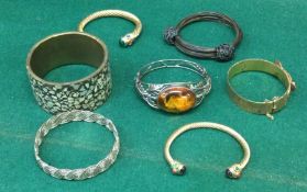 A quantity of silver and other bangles. Est. £20 -