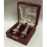 A pair of cased silver salt and peppers. Sheffield 1968. By FH. Approx. 62 grams. Est. £50 - £80.