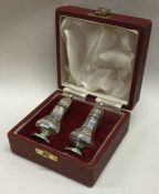 A pair of cased silver salt and peppers. Sheffield 1968. By FH. Approx. 62 grams. Est. £50 - £80.