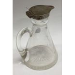 A silver mounted glass whisky noggin. Birmingham 1908. By Hukin and Heath. Est. £100 - £150.