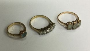 A group of three 9 carat gem set rings. Approx. 5.