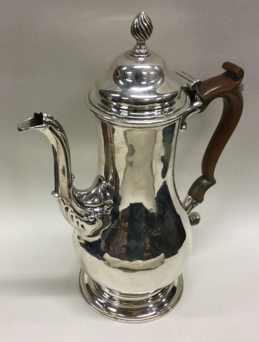 An 18th Century silver crested coffee pot. London 1764. Maker’s mark to base. Approx. 730 grams.