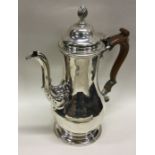 An 18th Century silver crested coffee pot. London 1764. Maker’s mark to base. Approx. 730 grams.