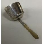 A George III bright cut silver and MOP caddy spoon. Birmingham 1807. By Joseph Taylor. Approx. 9