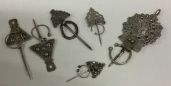 A group of five Eastern silver cloak pins. Approx.