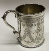 An engraved silver christening mug decorated with swags. London 1876. By William Evans. Approx.138