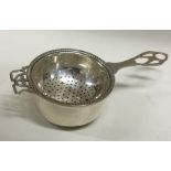 A heavy silver tea strainer on stand. Approx. 52 grams. Est. £100 – £150.