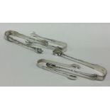 A group of four silver sugar tongs. Various dates