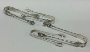 A group of four silver sugar tongs. Various dates